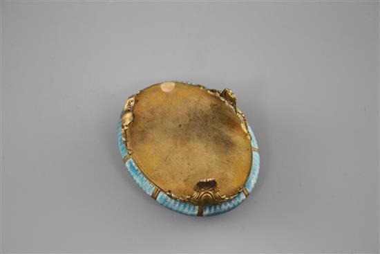 A late 19th century gilt metal and enamel oval box, decorated with a basket of flowers,
